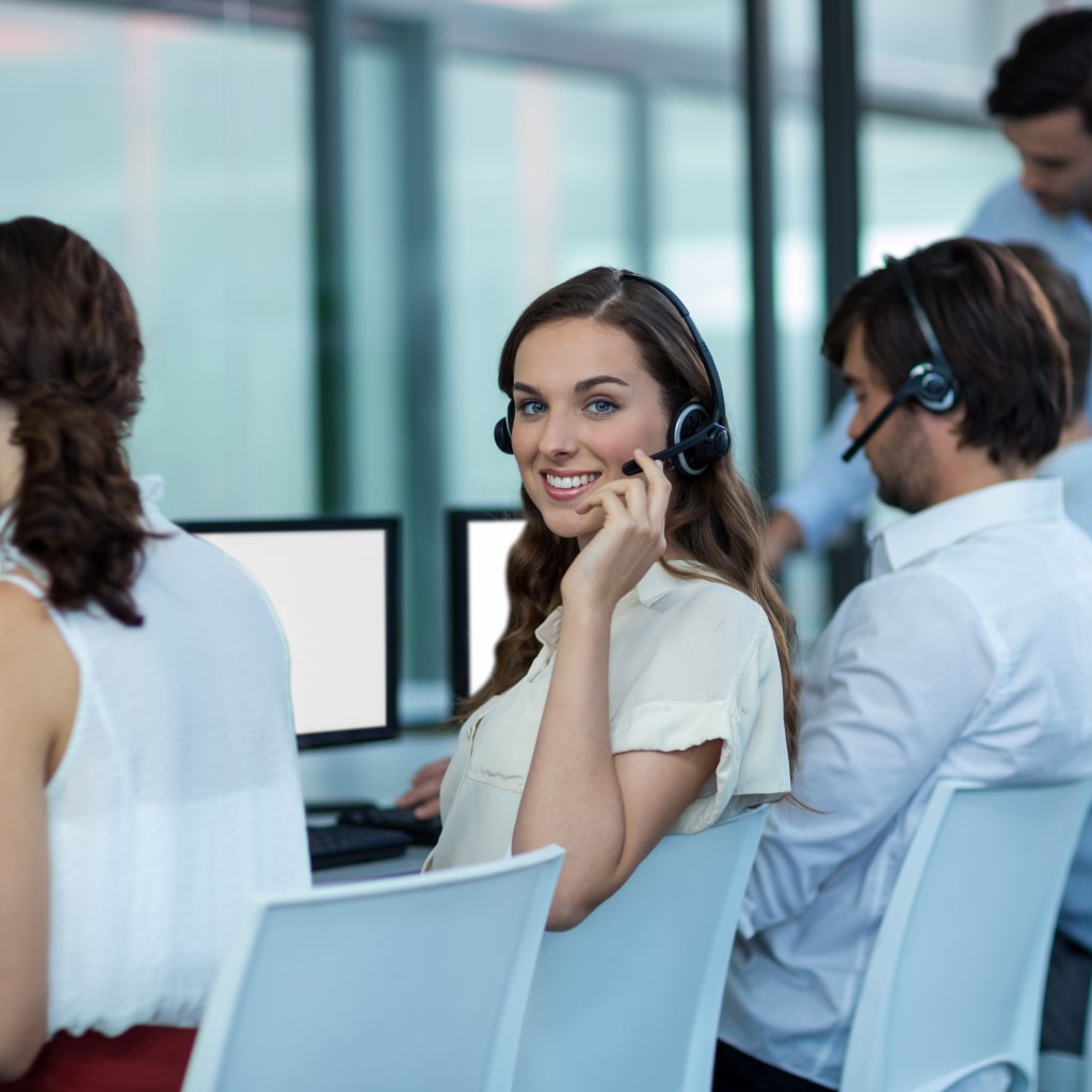 business-executives-with-headsets-using-computer 1-min